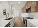 Modern kitchen with stainless steel appliances, eat-in island, and wood-style flooring at 1316 Lake Baldwin Ln, Orlando, FL 32814