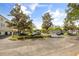 Wide shot of a parking lot with ample parking space and trees lining the perimeter at 1316 Lake Baldwin Ln, Orlando, FL 32814