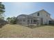 Fenced backyard with a large lawn and a view of the screened-in pool and spa at 14433 Huntingfield Dr, Orlando, FL 32824