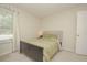 Cozy bedroom with a comfortable bed, soft carpet, window with blinds, and a light-filled atmosphere at 14433 Huntingfield Dr, Orlando, FL 32824
