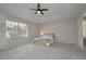 Spacious bedroom with natural light from the window and neutral decor at 14433 Huntingfield Dr, Orlando, FL 32824