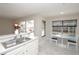 Well-lit kitchen with stainless steel appliances, bar seating and a view to the pool and breakfast nook at 14433 Huntingfield Dr, Orlando, FL 32824
