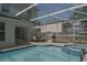 Backyard featuring a screened pool, patio and outdoor seating area at 14433 Huntingfield Dr, Orlando, FL 32824