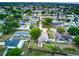 An aerial view shows lush green landscape, and well spaced homes at 1448 Lambert St, Deltona, FL 32725