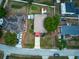 A top down aerial view of a home with a spacious driveway, green lawns, and mature trees at 1448 Lambert St, Deltona, FL 32725