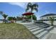Beautiful backyard with a multi-tiered waterfall feature, outdoor seating, and a lush lawn at 1448 Lambert St, Deltona, FL 32725