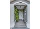 Charming front entrance with decorative plants and a covered porch leading to the front door at 1448 Lambert St, Deltona, FL 32725