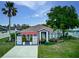 Charming single-story home with mature landscaping, decorative screens, and a covered front entrance at 1448 Lambert St, Deltona, FL 32725