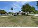 A large front yard with a well kept lawn and mature trees gives this home curb appeal at 1448 Lambert St, Deltona, FL 32725