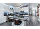 Modern kitchen featuring sleek white cabinets, a granite countertop island, and stainless steel appliances at 1448 Lambert St, Deltona, FL 32725
