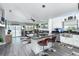 Open-concept living space with a modern kitchen, island seating, and access to the backyard at 1448 Lambert St, Deltona, FL 32725