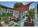 Relaxing outdoor patio with comfortable seating, a shade sail, and views of the landscaped yard at 1448 Lambert St, Deltona, FL 32725