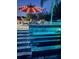 Backyard view of pool waterfall feature with an umbrella and seating area at 1448 Lambert St, Deltona, FL 32725