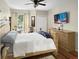 Inviting bedroom featuring a ceiling fan, TV, and large dresser for ample storage at 1475 Lake Shadow Cir # 6205, Maitland, FL 32751