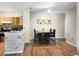 Bright dining area with wood-style floors and a decorative stone-accented breakfast bar at 1475 Lake Shadow Cir # 6205, Maitland, FL 32751