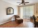 Cozy living room featuring wood floors, a ceiling fan, and sliding glass doors to a balcony at 1475 Lake Shadow Cir # 6205, Maitland, FL 32751