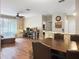 Inviting living space featuring wood floors, comfortable seating, and an adjacent dining area with stone accents at 1475 Lake Shadow Cir # 6205, Maitland, FL 32751