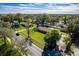 Aerial view capturing the house and surrounding neighborhood with lush greenery and clear blue skies at 1624 Bel Air Ave, Orlando, FL 32812
