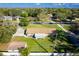 Aerial view of a home with a sprawling green lawn and mature trees in a serene neighborhood at 1624 Bel Air Ave, Orlando, FL 32812