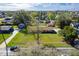 An aerial view shows the property's well-maintained lawn, mature trees, and a quiet residential neighborhood skyline view with property lines at 1624 Bel Air Ave, Orlando, FL 32812