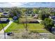 An aerial view shows the property's well-maintained lawn, mature trees, and a quiet residential neighborhood skyline view at 1624 Bel Air Ave, Orlando, FL 32812