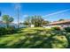 A beautifully manicured backyard with lush green grass, trees, and fence at 1624 Bel Air Ave, Orlando, FL 32812