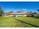 A view of the backyard with lush green grass and view of home at 1624 Bel Air Ave, Orlando, FL 32812