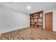Basement with wooden floors and a built-in wooden bookcase at 1624 Bel Air Ave, Orlando, FL 32812