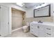 Bathroom features tiled walk-in shower, white vanity with drawers and cabinets, new fixtures, stylish mirror at 1624 Bel Air Ave, Orlando, FL 32812