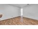 A spacious bedroom with wood laminate flooring and white walls and trim at 1624 Bel Air Ave, Orlando, FL 32812