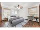 Well-lit bedroom featuring a ceiling fan, window blinds, and desk setup at 1624 Bel Air Ave, Orlando, FL 32812
