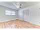 Bright bedroom with hardwood floors, a ceiling fan, a window, and a closet with bi-fold doors at 1624 Bel Air Ave, Orlando, FL 32812