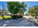 Property featuring a long driveway, fenced yard, mature trees, and a well-kept front lawn at 1624 Bel Air Ave, Orlando, FL 32812