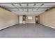 A spacious garage with storage cabinets, work area, and concrete flooring at 1624 Bel Air Ave, Orlando, FL 32812