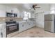 Modern kitchen with stainless steel appliances, white cabinets, and a stylish tile backsplash at 1624 Bel Air Ave, Orlando, FL 32812