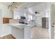 Spacious kitchen features white cabinets, stainless appliances, and a convenient breakfast bar at 1624 Bel Air Ave, Orlando, FL 32812