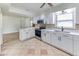 Kitchen with tile floors, white cabinets, stainless steel appliances, and a breakfast bar at 1624 Bel Air Ave, Orlando, FL 32812
