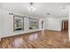 Inviting living room with gleaming hardwood floors, large windows, and plenty of natural light at 1624 Bel Air Ave, Orlando, FL 32812