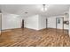 Spacious living room featuring wood floors, white walls, recessed lighting, and neutral tones at 1624 Bel Air Ave, Orlando, FL 32812