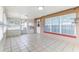 Enclosed outdoor patio space with tile flooring, windows, and a doorway at 1624 Bel Air Ave, Orlando, FL 32812