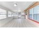 Enclosed outdoor patio space with tile flooring, windows, and a doorway at 1624 Bel Air Ave, Orlando, FL 32812