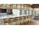 Modern bar area with bar seating, wood and stainless steel finishes and a light neutral palette at 1644 Tropical Palms Cir, Kissimmee, FL 34747