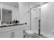 Bright bathroom featuring a walk-in shower, granite countertop vanity, and tiled floor at 1644 Tropical Palms Cir, Kissimmee, FL 34747