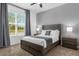 Serene bedroom with a plush bed, large window, and soft natural light at 1644 Tropical Palms Cir, Kissimmee, FL 34747