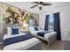 Bright bedroom featuring twin beds, ceiling fan, and a wall with Marvel superhero character art at 1644 Tropical Palms Cir, Kissimmee, FL 34747