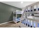 Spacious bedroom featuring two sets of wooden bunk beds and a cool-toned accent wall at 1644 Tropical Palms Cir, Kissimmee, FL 34747