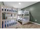 Spacious bedroom featuring two sets of wooden bunk beds and a cool-toned accent wall at 1644 Tropical Palms Cir, Kissimmee, FL 34747