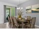 Elegant dining room with a dining table set for eight, complemented by neutral decor at 1644 Tropical Palms Cir, Kissimmee, FL 34747