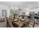 Open concept dining area with a table set for eight and seamless flow to kitchen and living room at 1644 Tropical Palms Cir, Kissimmee, FL 34747