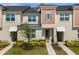 Charming two-story townhome featuring well-maintained landscaping and a welcoming entrance at 1644 Tropical Palms Cir, Kissimmee, FL 34747